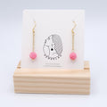 Pendientes colgantes de cristal rosa con acero inoxidable dorado